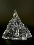 Transparent iceberg-shaped candle with unlit wick, cool gray crystal-like wax