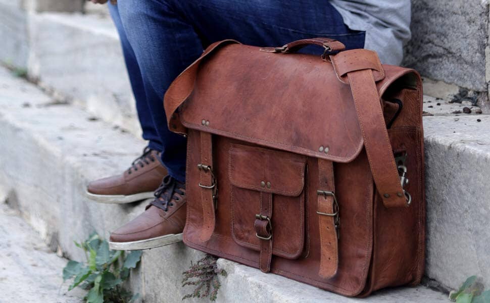 Brown leather satchel briefcase with flap top and front buckle straps