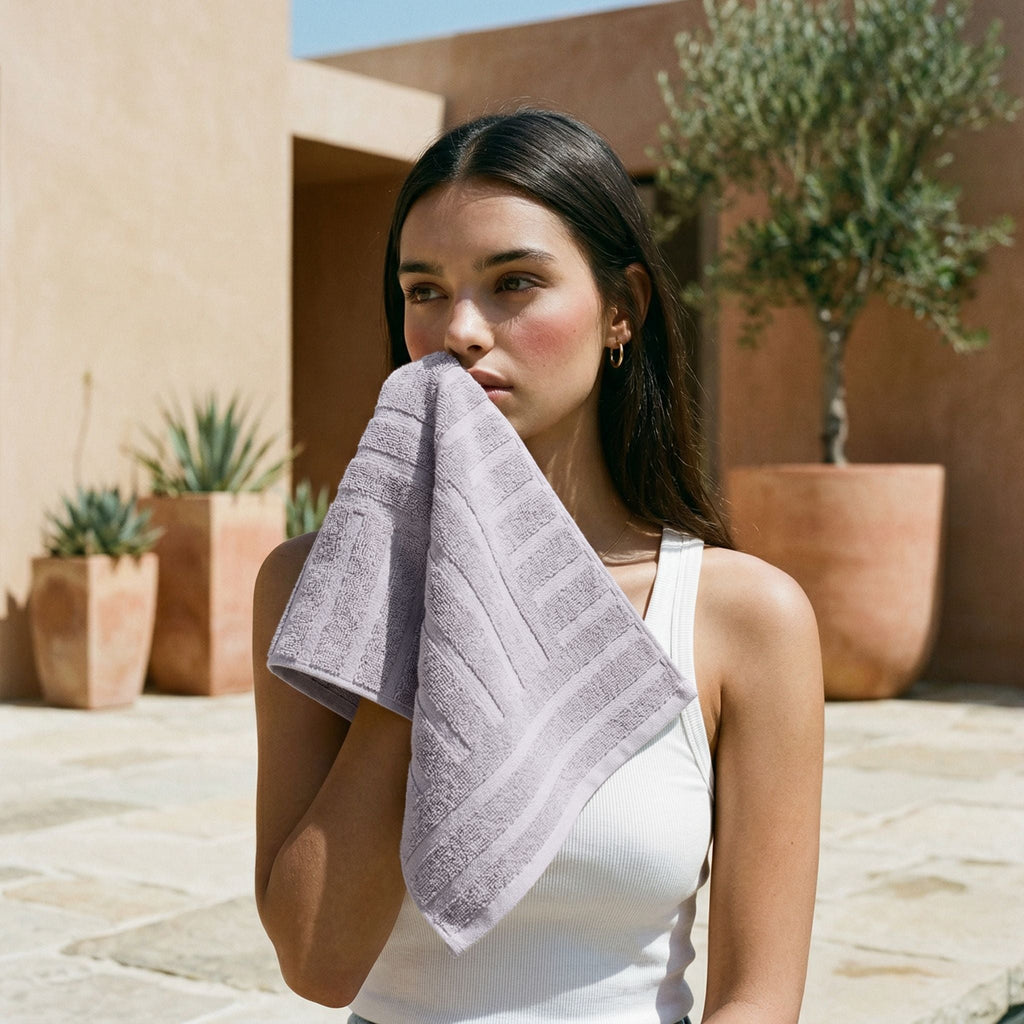 Lilac cotton towel, folded over arm for lounging outdoors