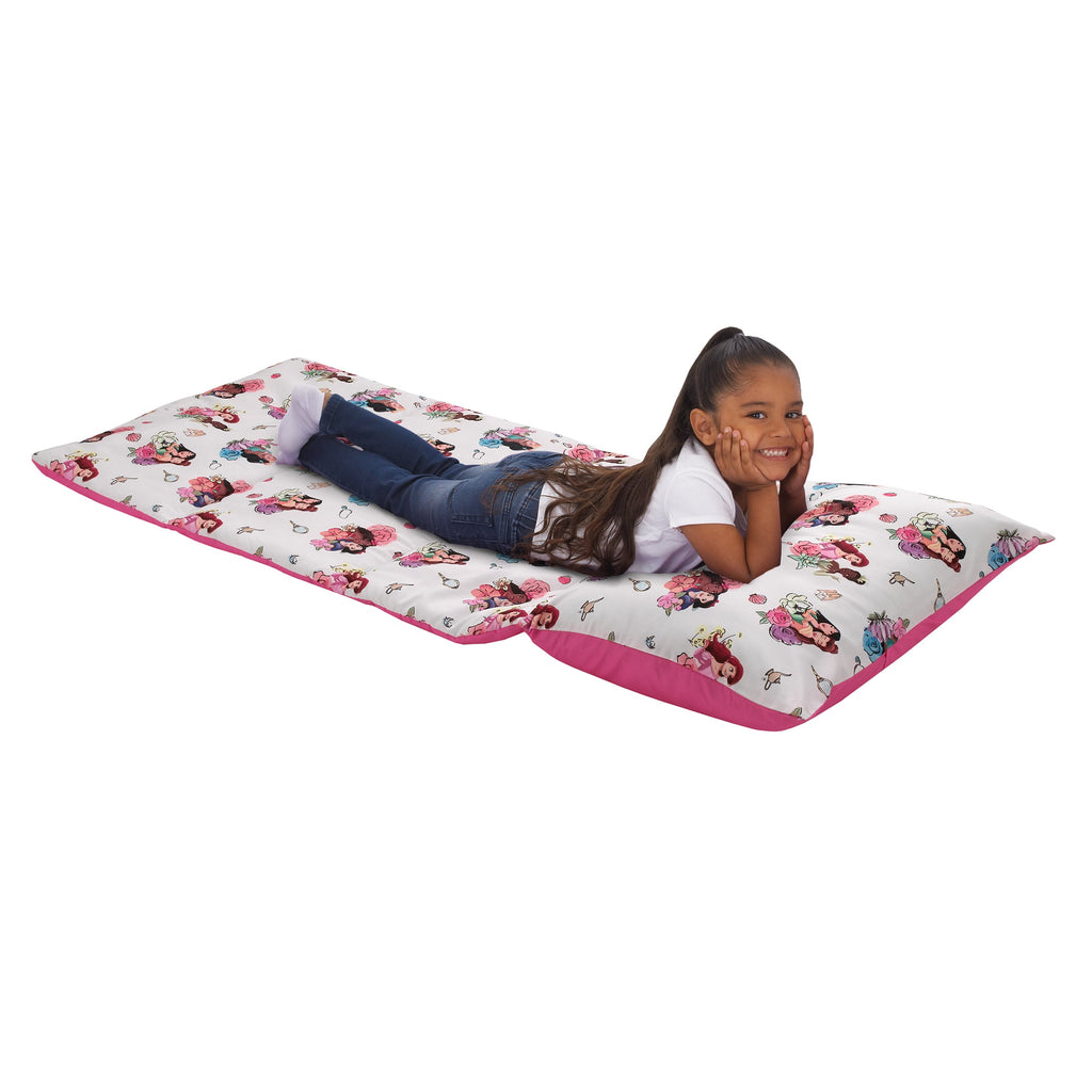 Toddler nap mat with white princess print and pink edging, laid out for sleeping