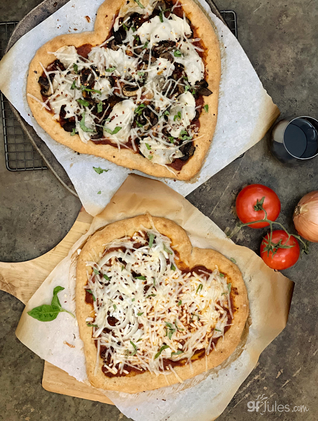 Gluten-free pizza on baking paper with melted cheese, greens, and shredded topping