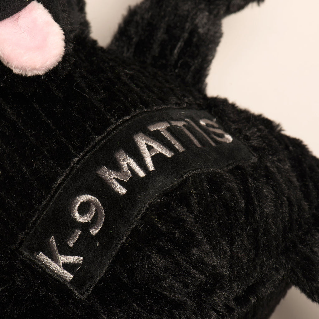 Black plush chest patch with embroidered 'K-9 MATTIS' lettering