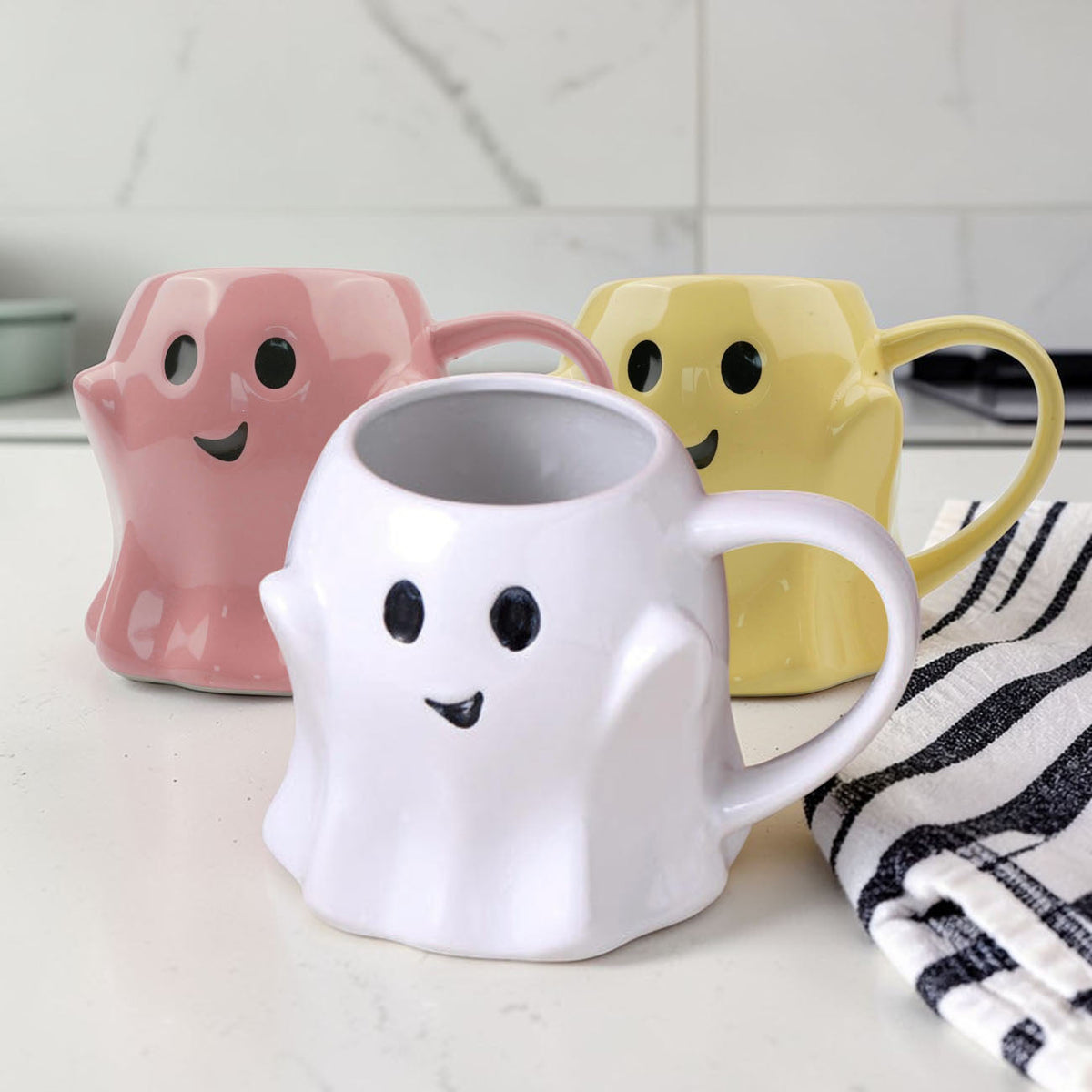 White ghost-shaped ceramic mug with smiling face and curved handle
