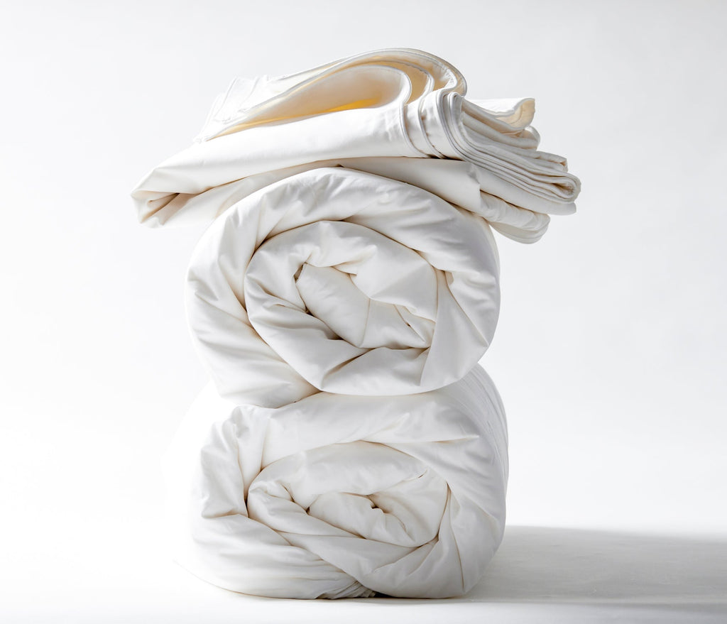 White silk-filled duvet folded with layered edges and a smooth outer surface