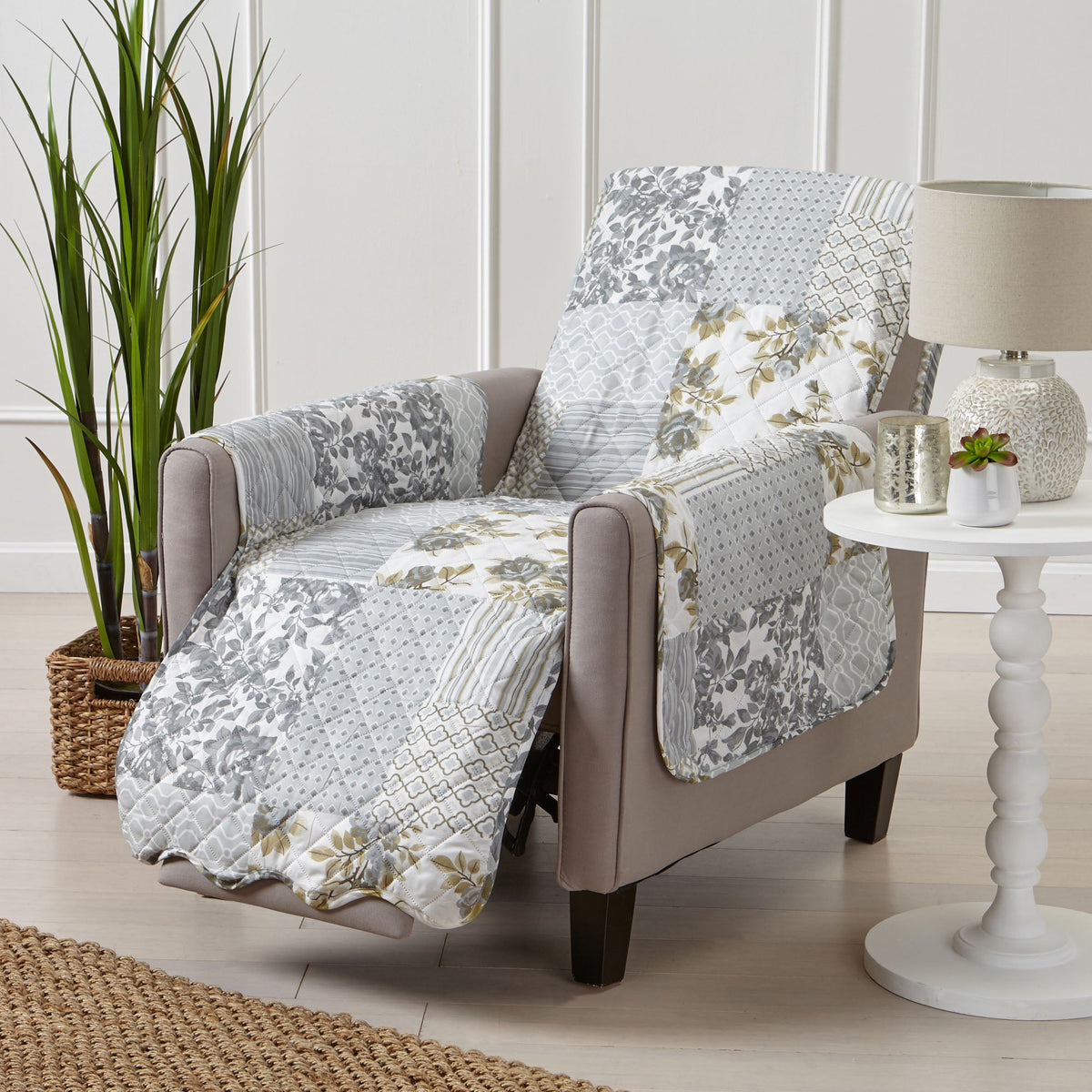 Reversible furniture protector with gray, white, and gold patchwork floral and geometric coverage