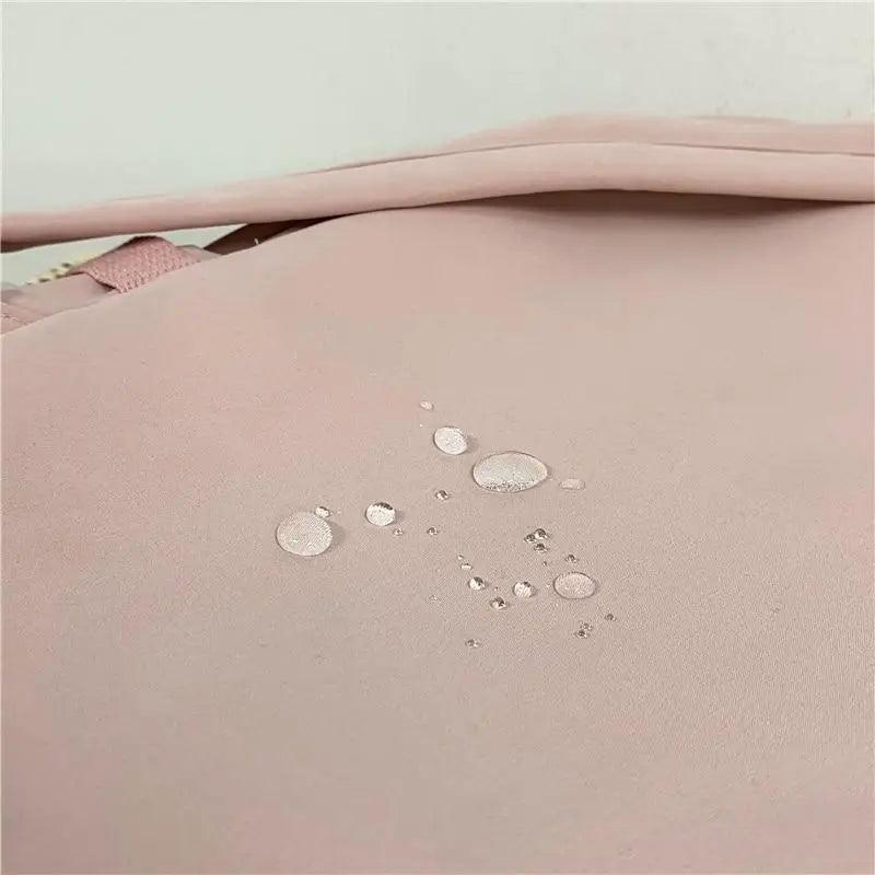 Pink nylon fabric with visible water droplets for water-repellent protection