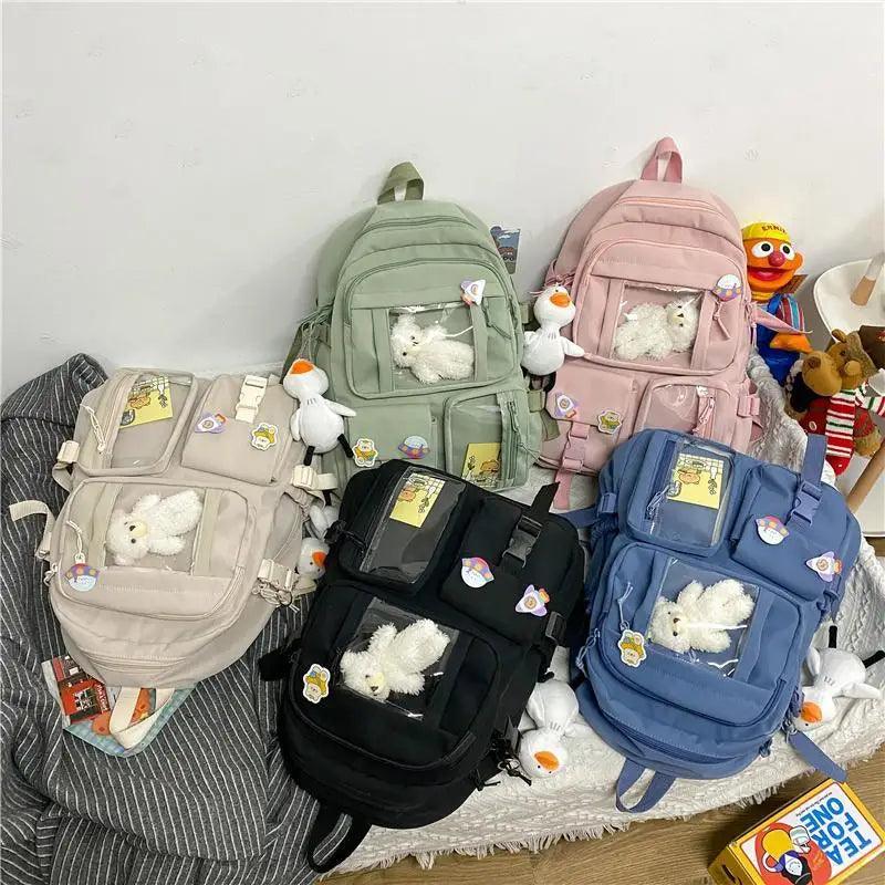 Assorted cute backpacks set: mint, pink, beige, black, and blue with plush charms