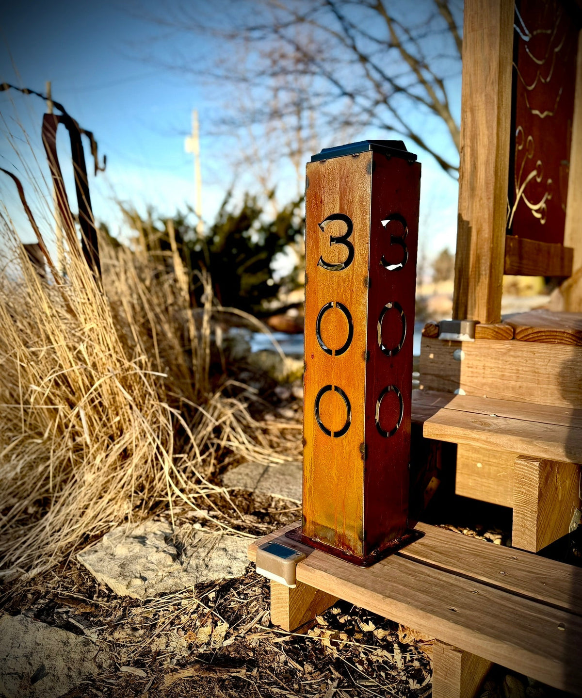 Rust-style solar address pillar light with numbers 3, 3, 0 and 0 on a post