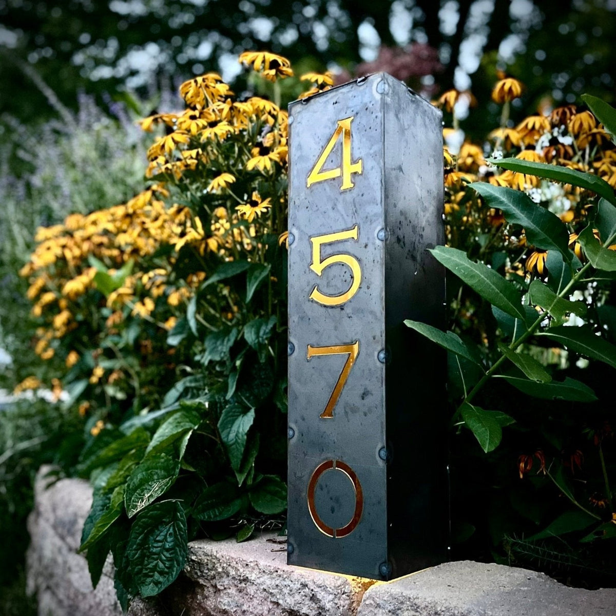 Steel solar address pillar light with visible numbers 4, 5, 7 and 6