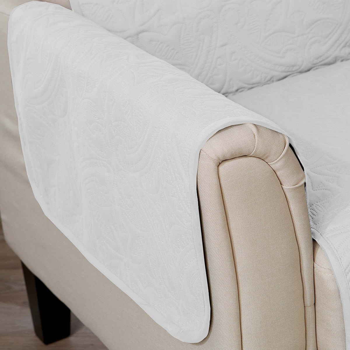 White armchair protector draped over beige armrest with smooth curved fit