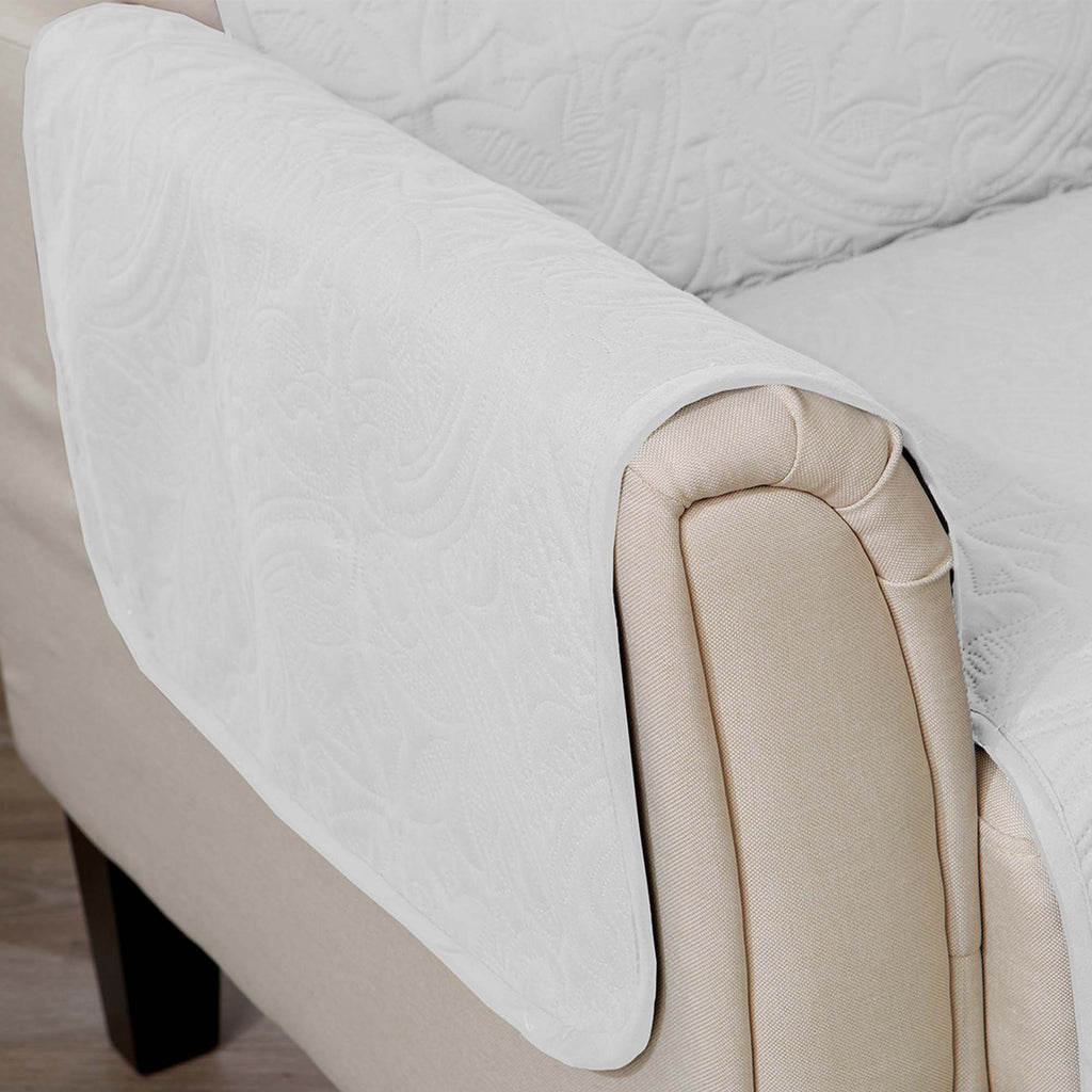 White medallion sofa protector with beige backing and rounded arm cover detail