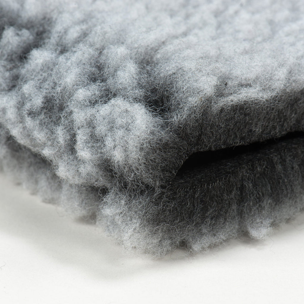 Close-up of gray fleece mat bed with fluffy, textured surface