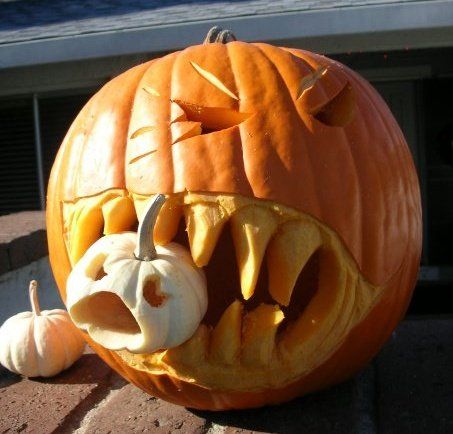 Carved orange jack-o-lantern with triangular cut eyes and mouth