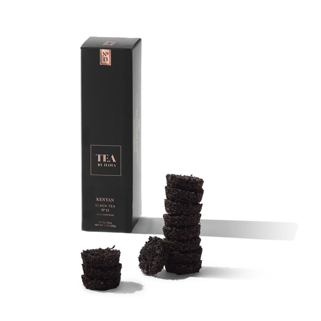 Kenyan No. 13 black tea box displayed with several pressed tea discs