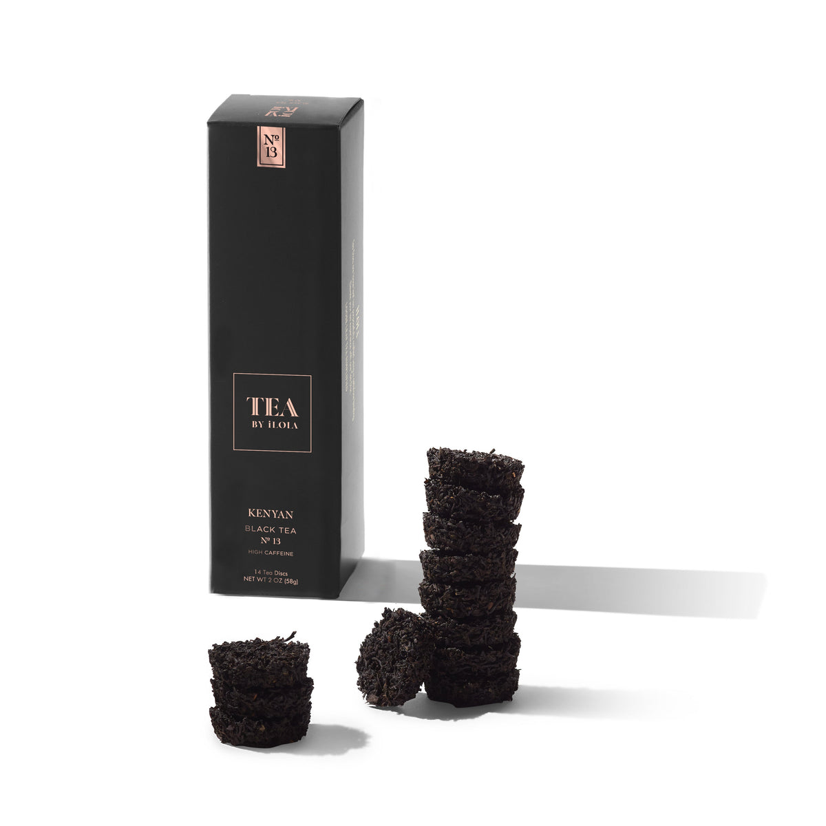 Kenyan No. 13 black tea box displayed with several pressed tea discs