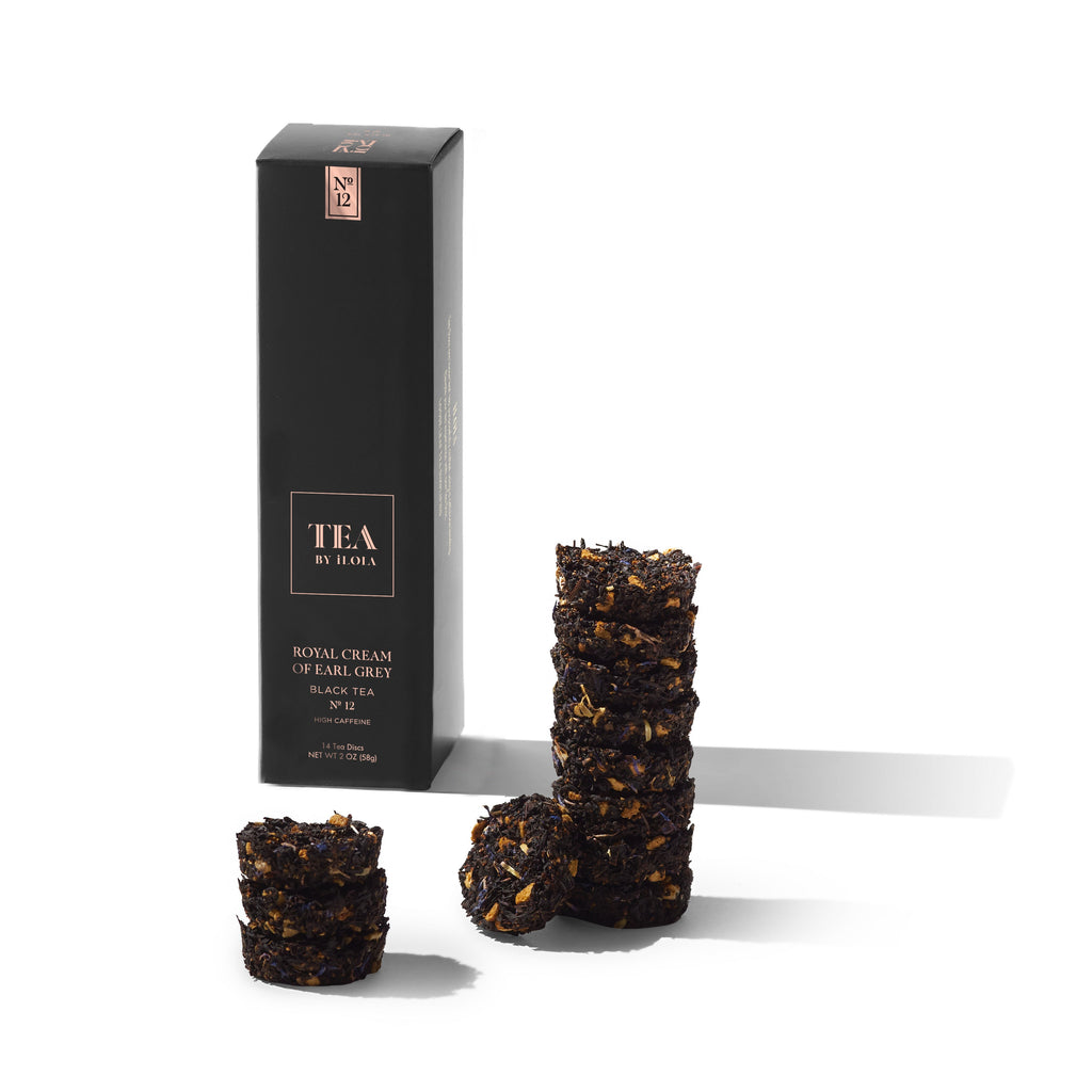 Earl Grey black tea discs beside a tall tea box.
