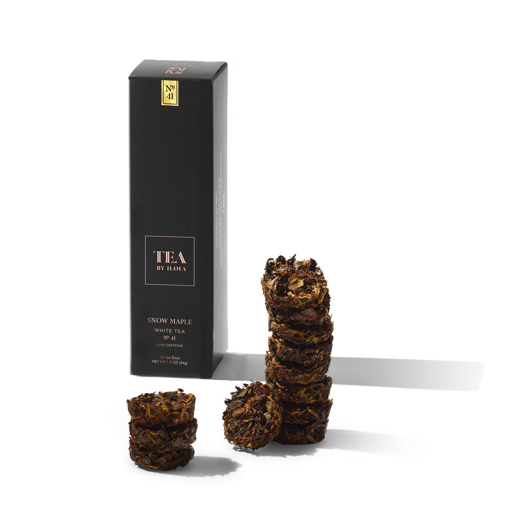 Snow Maple No. 41 tea box beside several compressed tea discs