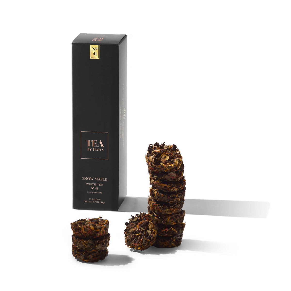 Snow Maple No. 41 tea box beside several compressed tea discs