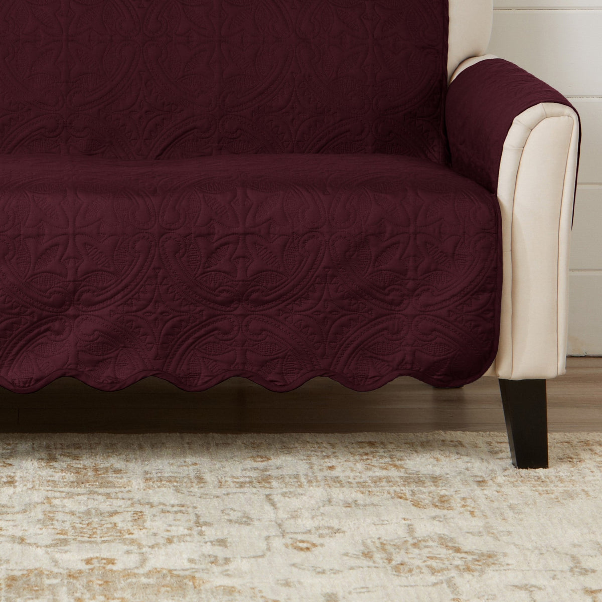 Burgundy recliner protector with medallion pattern covering seat and side