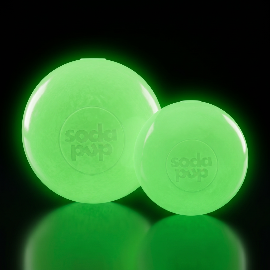 Glowing neon green rubber squeaky dog ball toy with soda pup logo, two balls