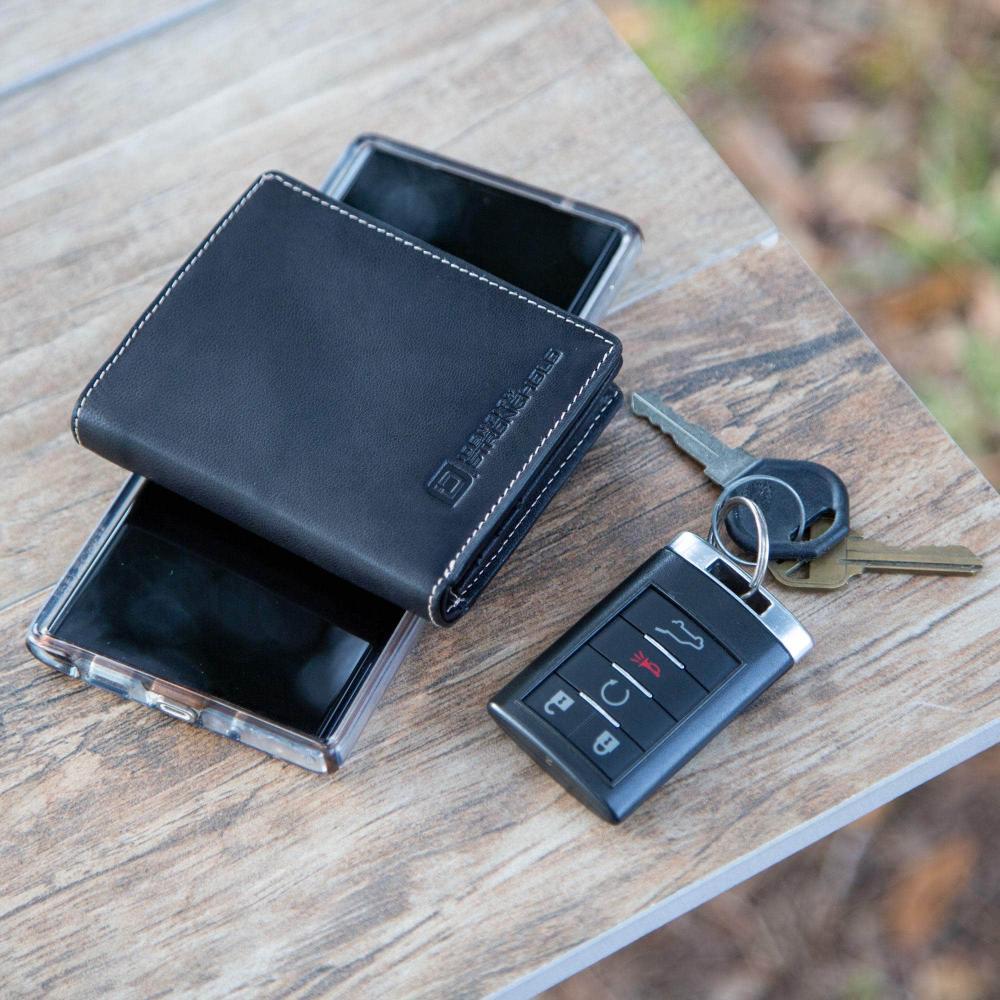 Minimalist RFID wallet, dark blue leather with stitched edge, shown with keys