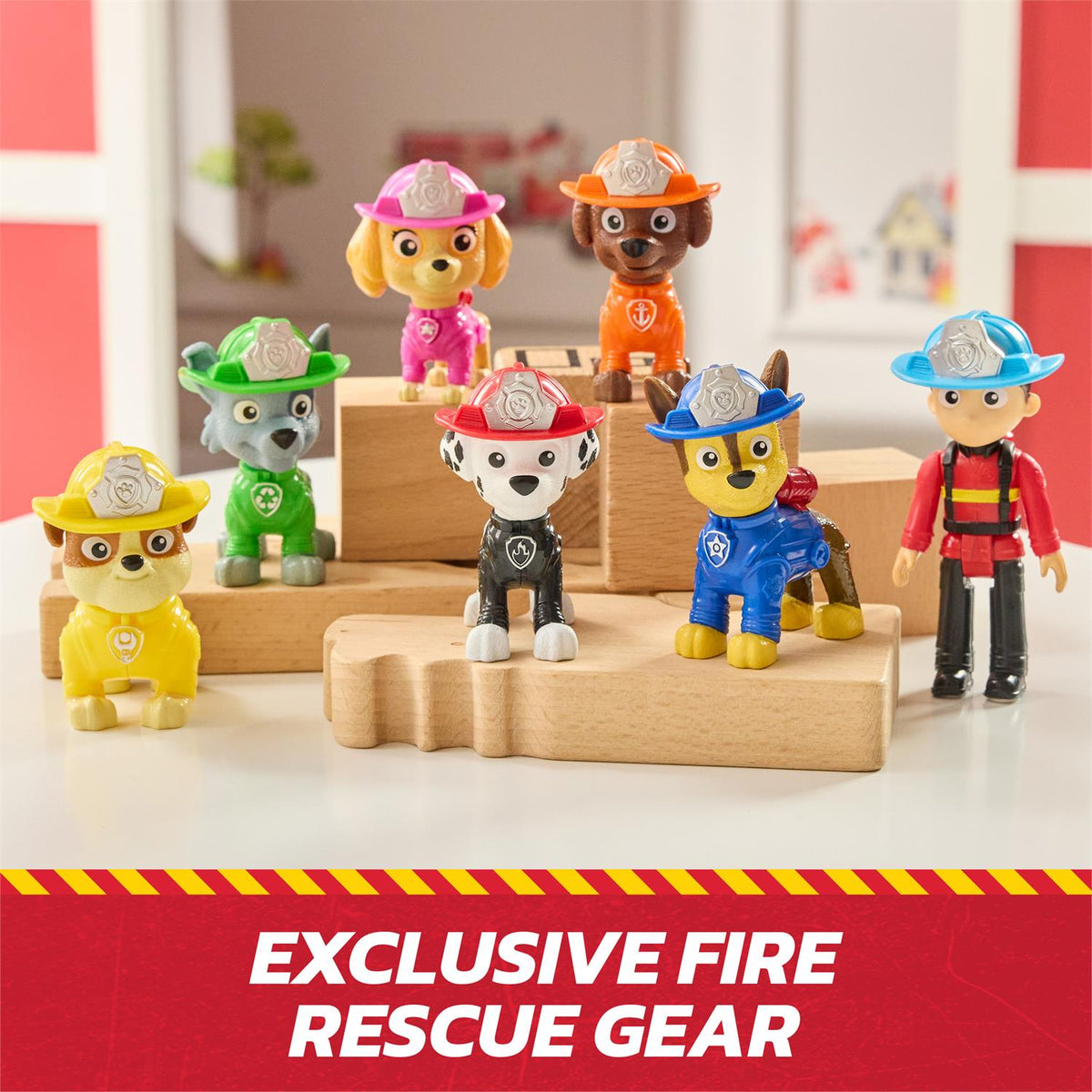PAW Patrol fire rescue toy pups and rider posed on a wooden display block