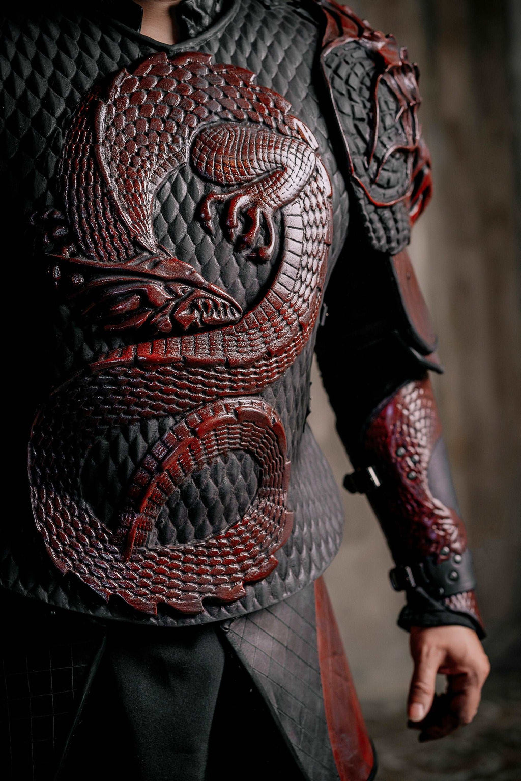 Red-and-gray scale armored chest piece with shoulder guards and black undershirt