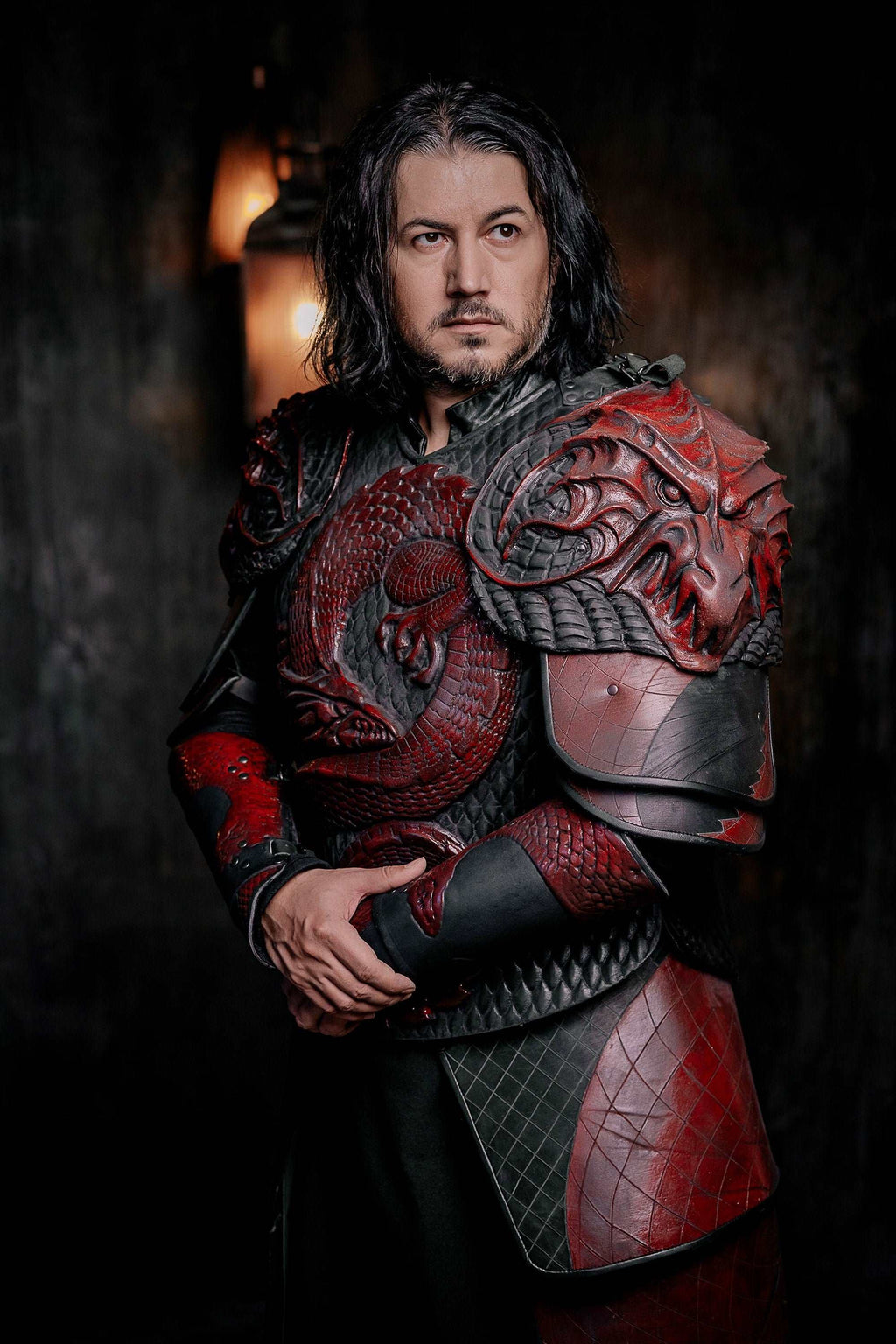 Vampire knight armor costume with red-and-silver scale chest armor and armored bracers