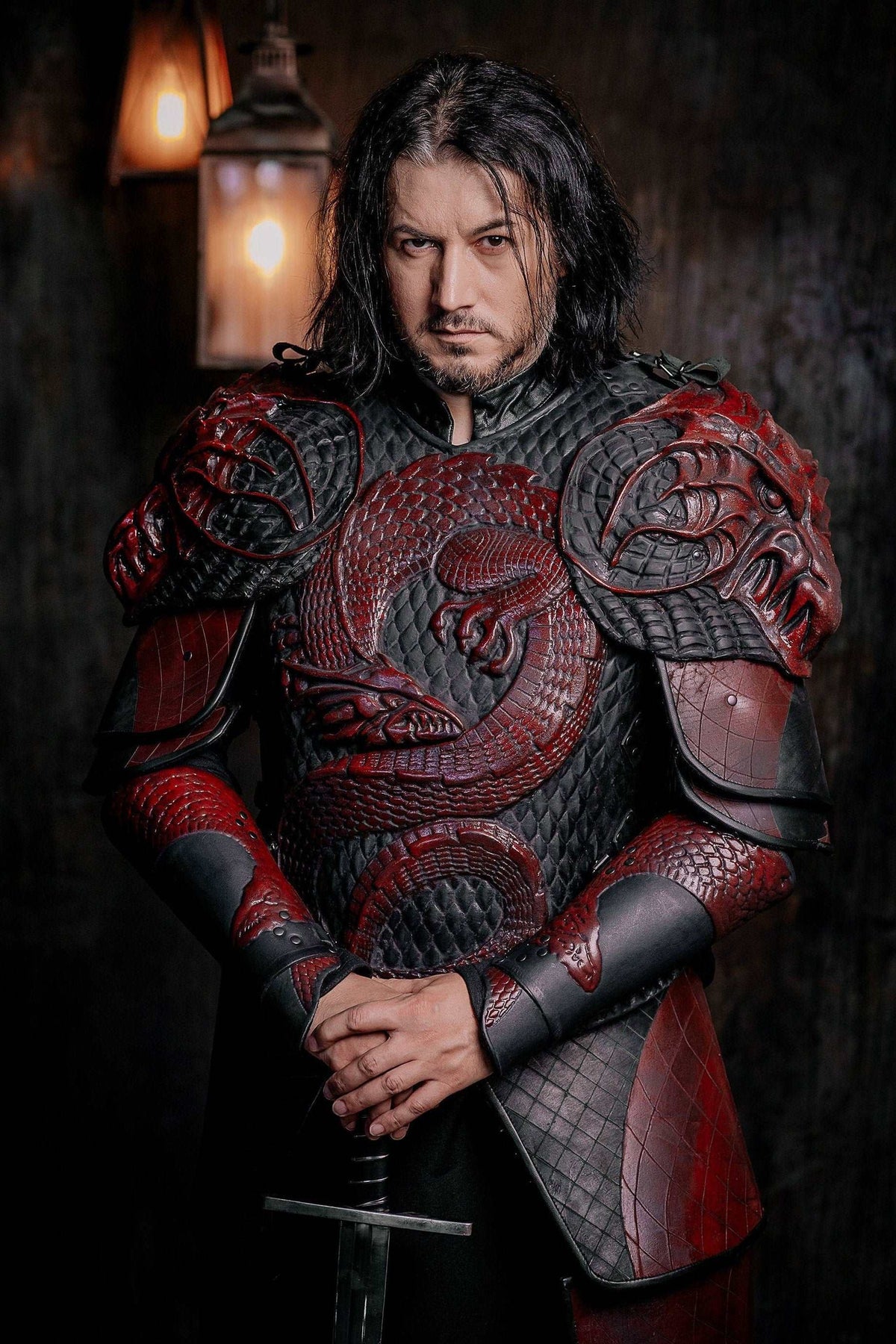 Vampire knight armor costume with detailed red-trimmed plate pauldrons and chained gauntlets