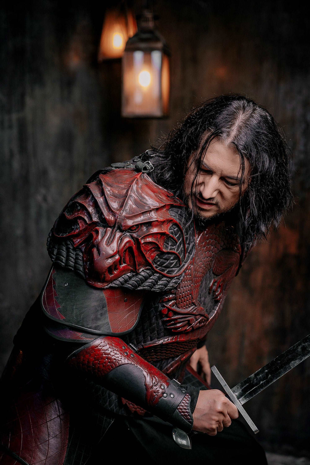 Vampire knight armor costume with red cape sleeves and sword, crouched pose
