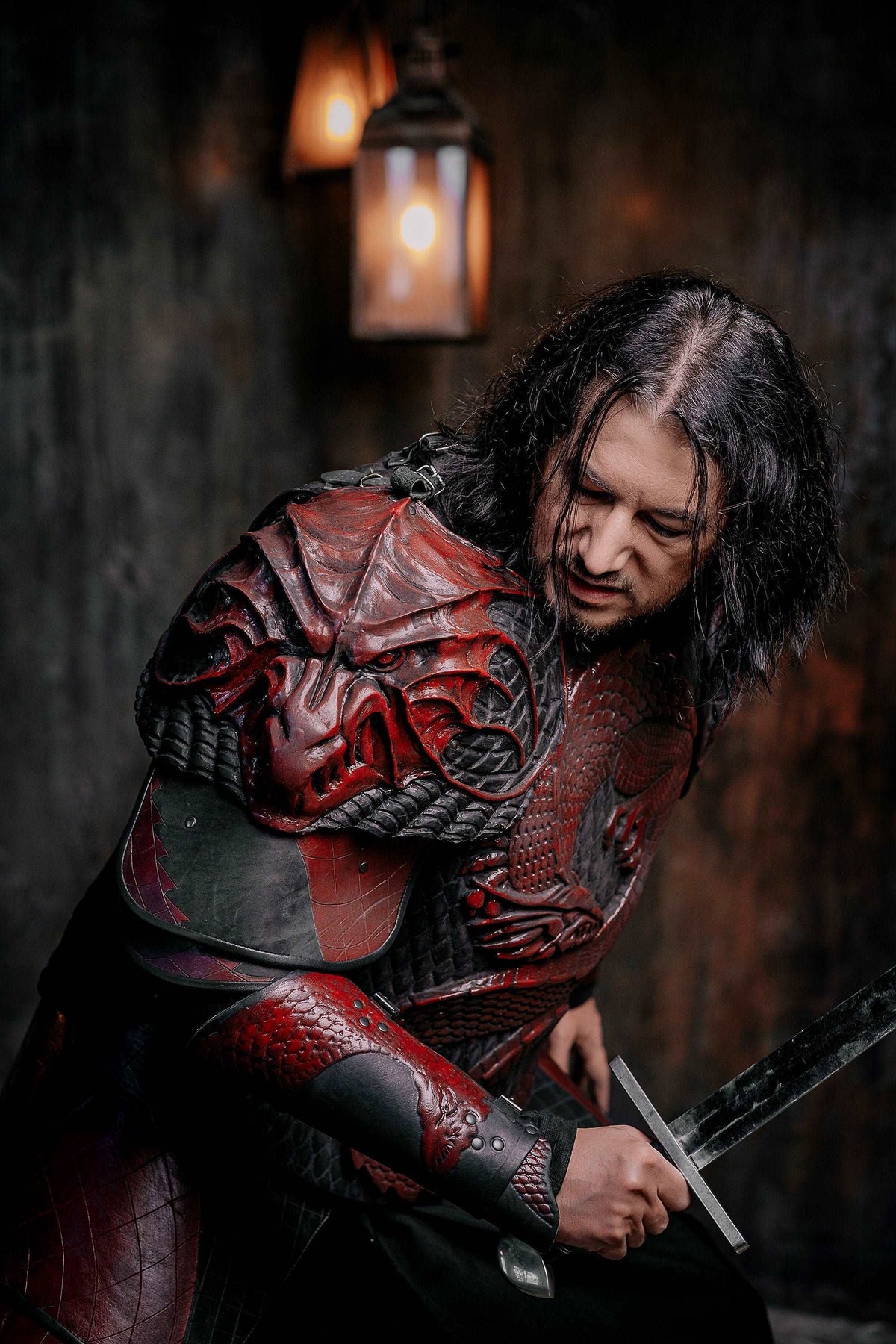 Vampire knight armor costume with red cape sleeves and sword, crouched pose