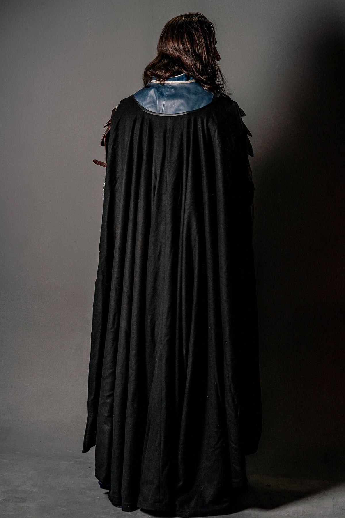 Black flowing cape with draped shoulder collar, back view