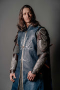 Blue medieval tunic with silver tree embroidery, plus plated shoulder and arm armor