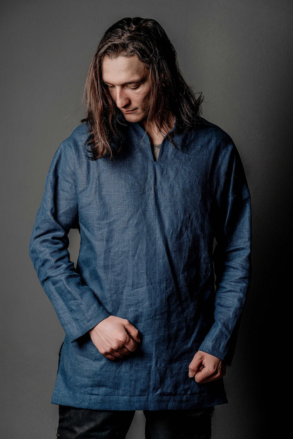 Blue long-sleeve tunic with V-neck opening and textured fabric