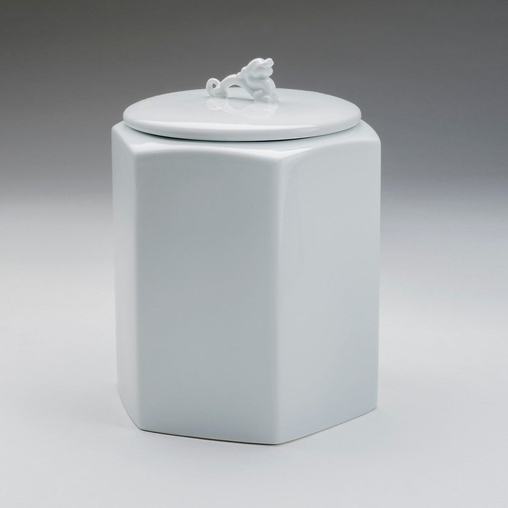 White hexagonal porcelain jar with dragon finial on round lid