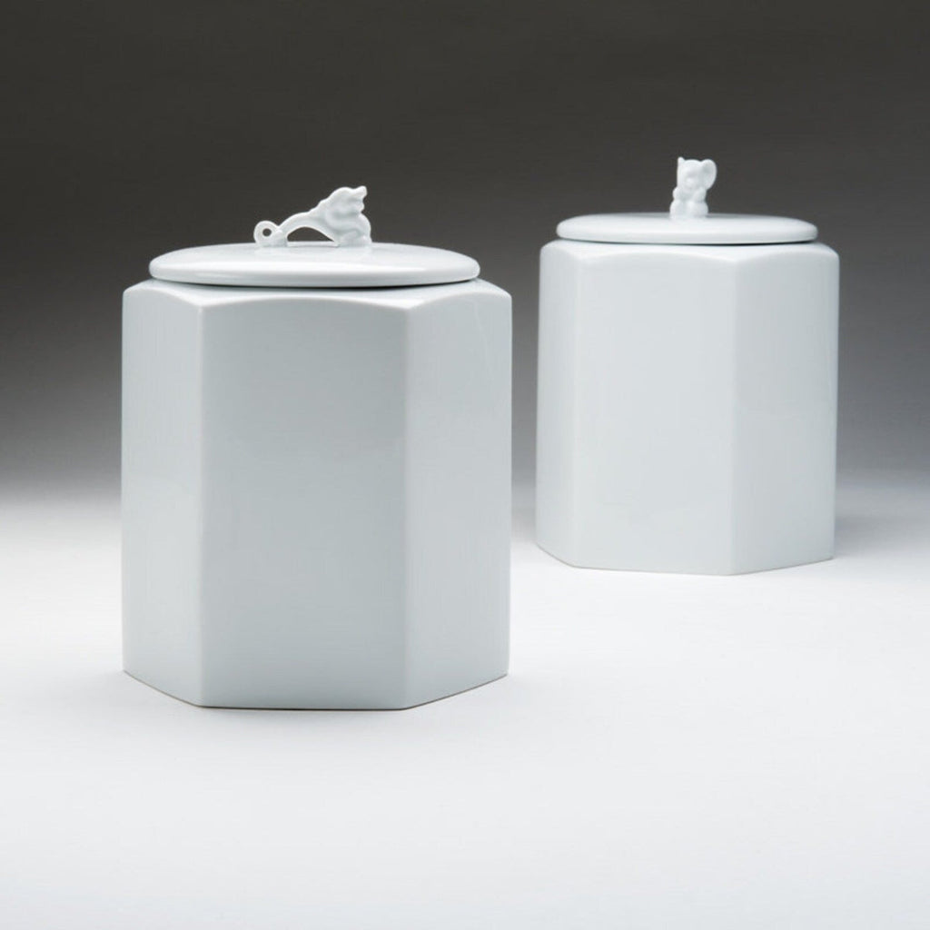 Set of two white hexagonal porcelain storage jars with dragon-lid finials