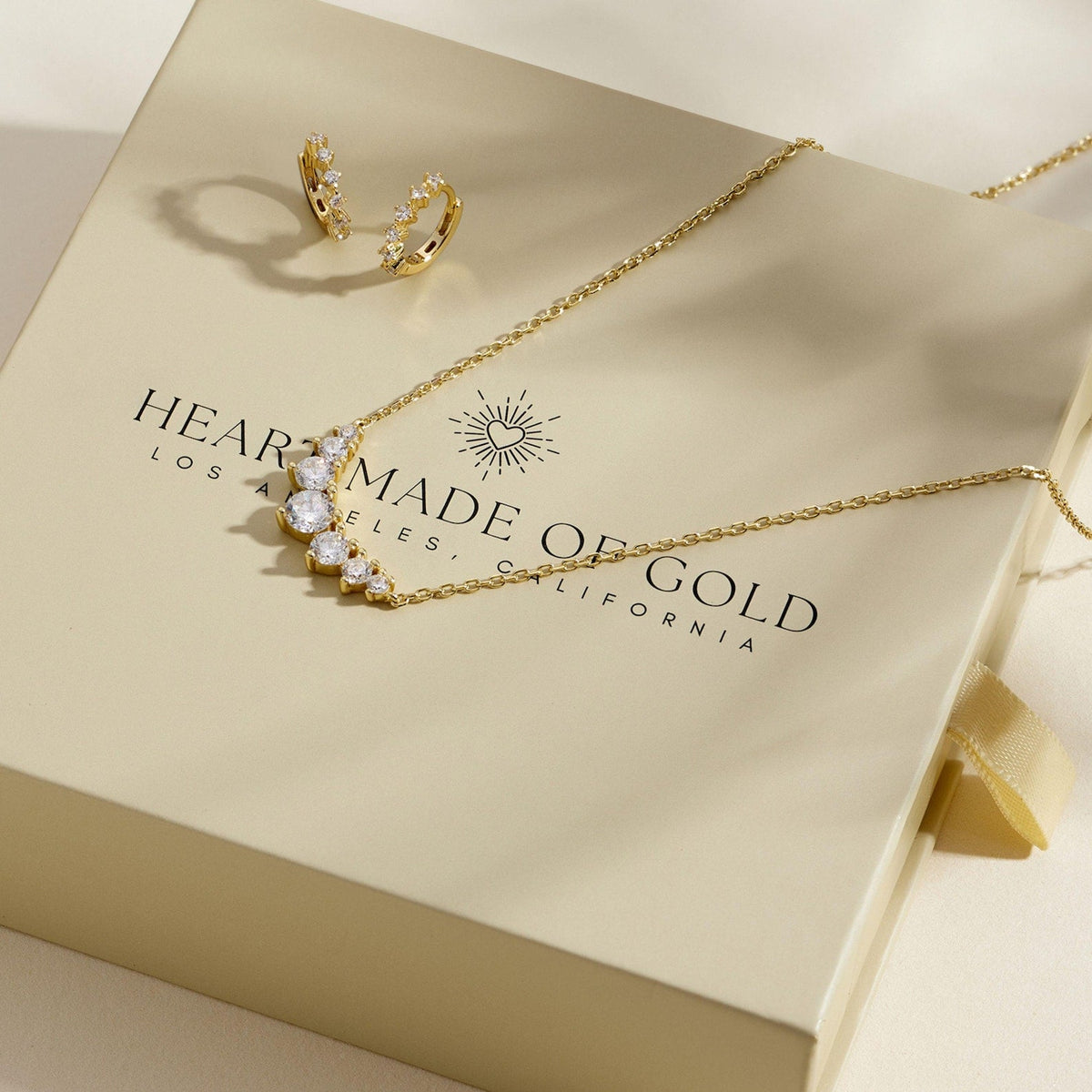 Gold-tone cluster diamond necklace with matching hoop earrings