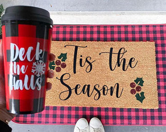 Holiday doormat featuring “’Tis the Season” lettering with snowflake decorations