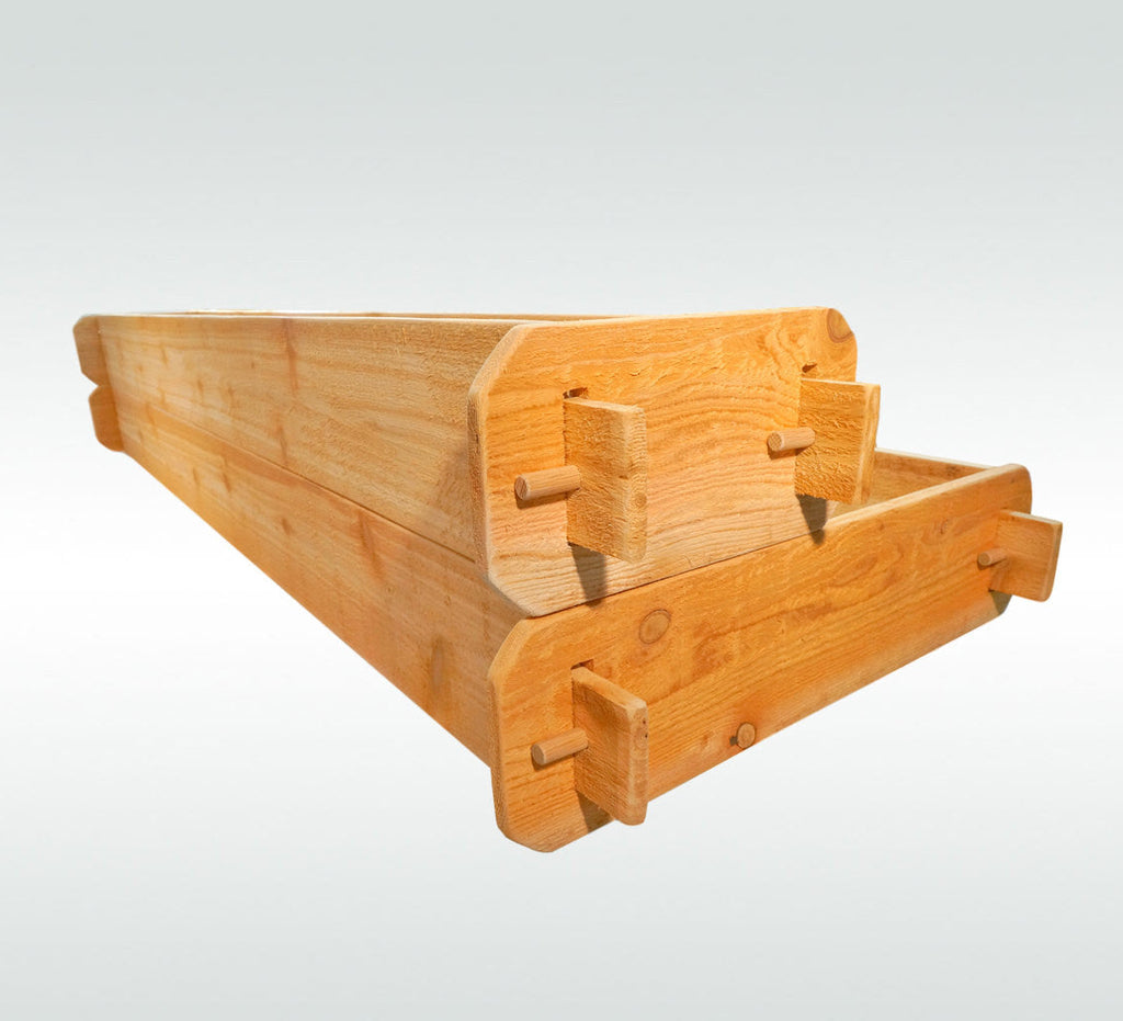 Cedar raised garden bed kit end view with stacked boards and wood connector brackets