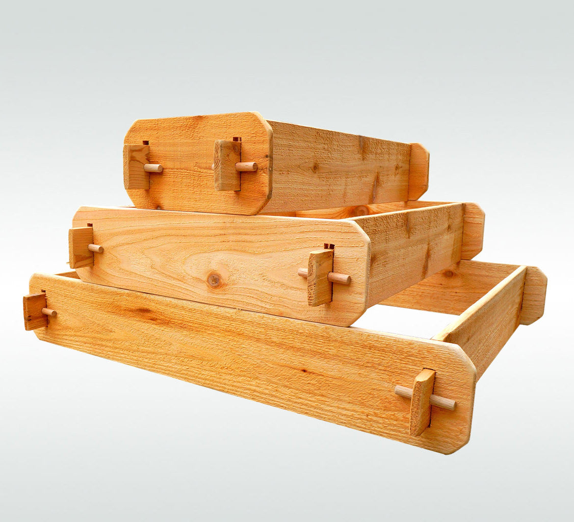 Three-tier raised cedar garden bed frame with stacked compartments and corner joinery, studio