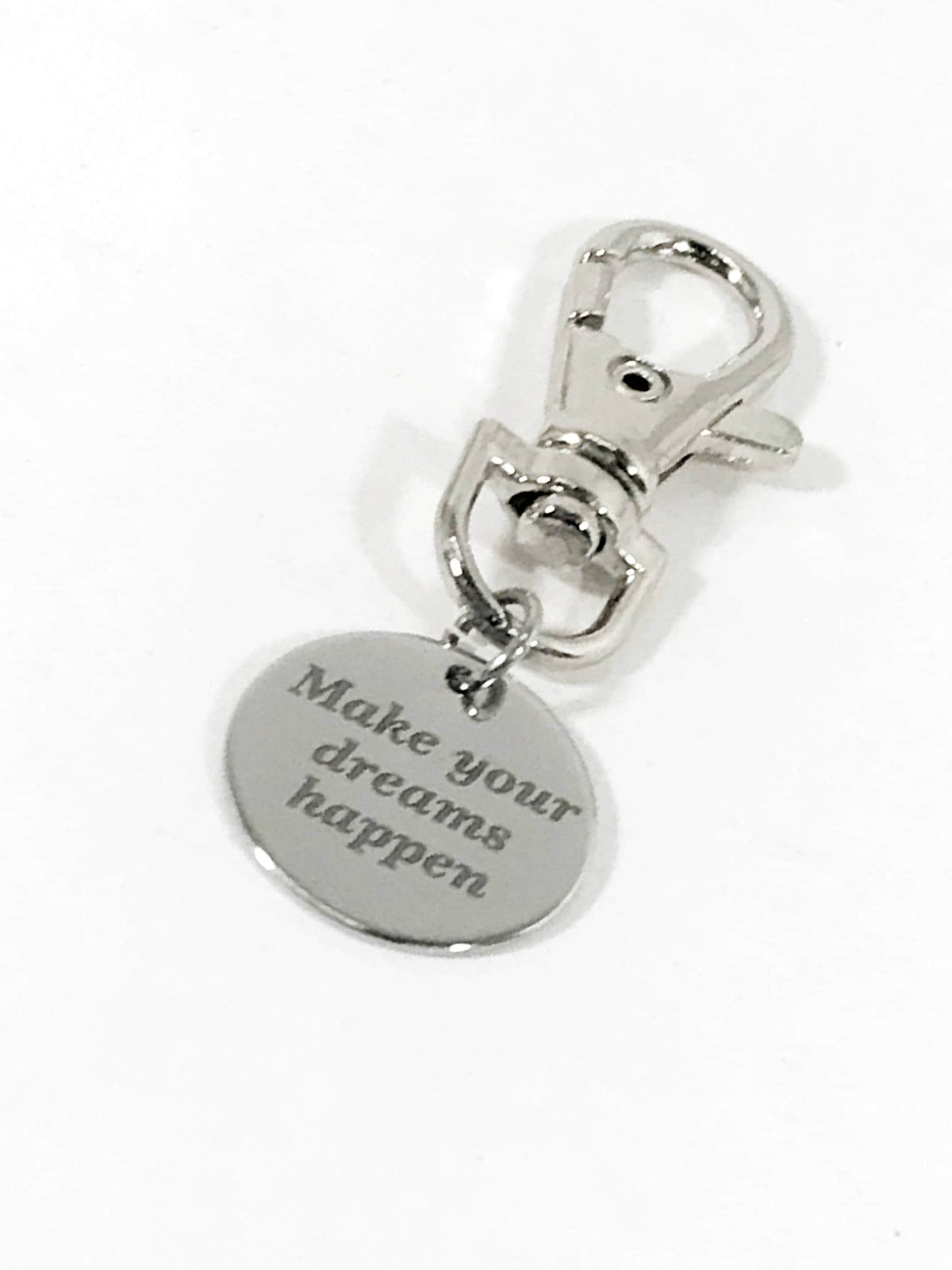Silver metal luggage tag with round heart-shaped engraved motivational text and swivel clasp.