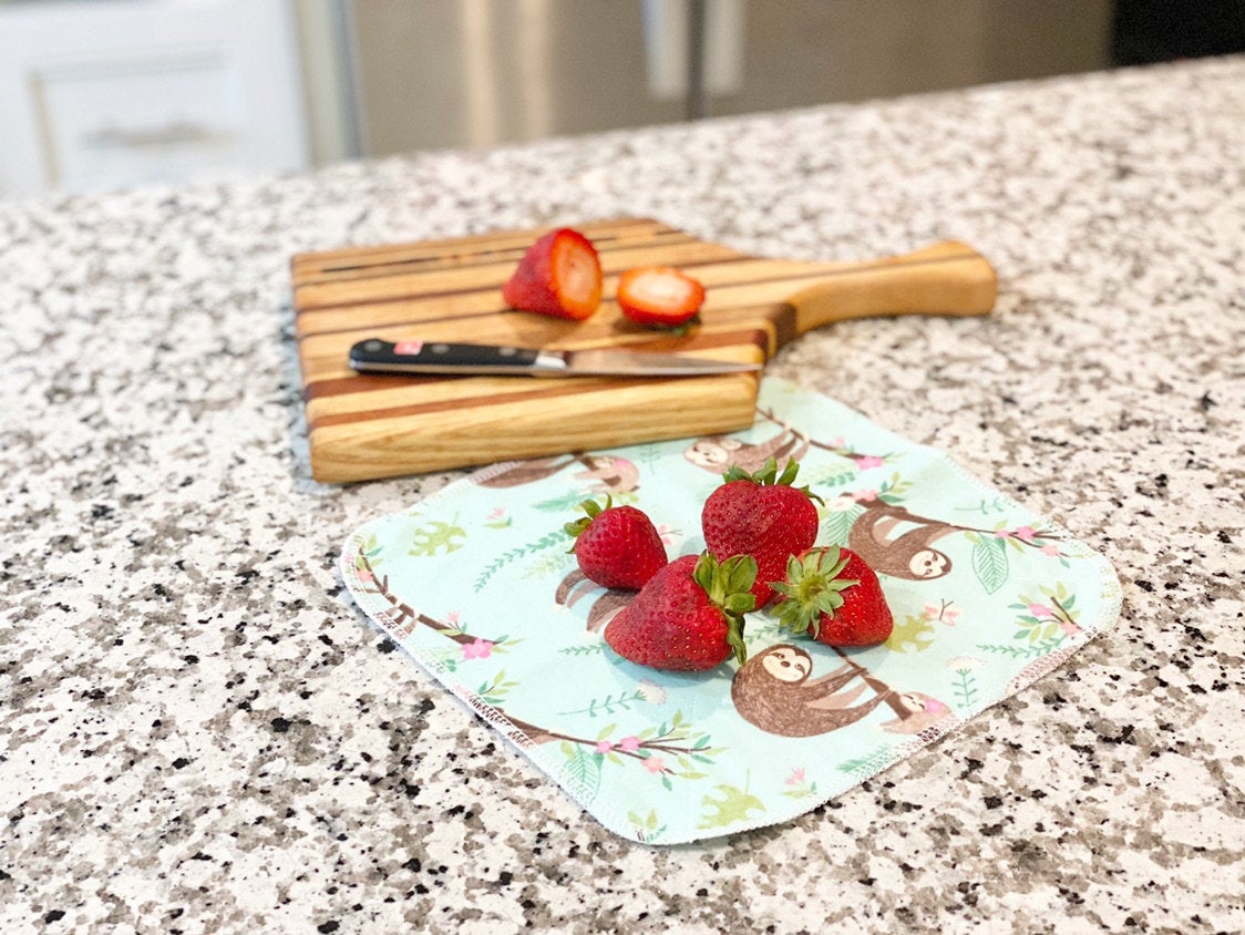 Reusable paper towel on countertop with strawberry and berry woodland pattern