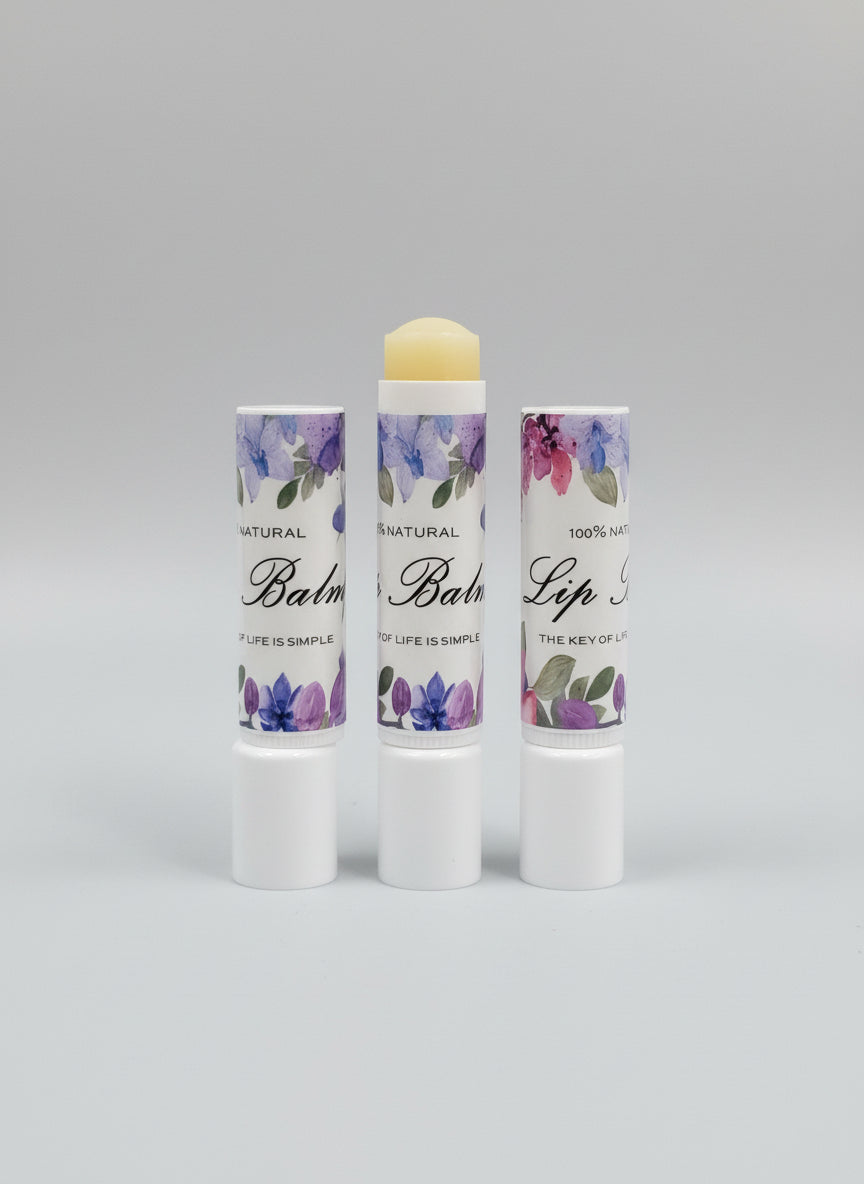 Floral lip balm chapstick in white tube with purple and pink flower print