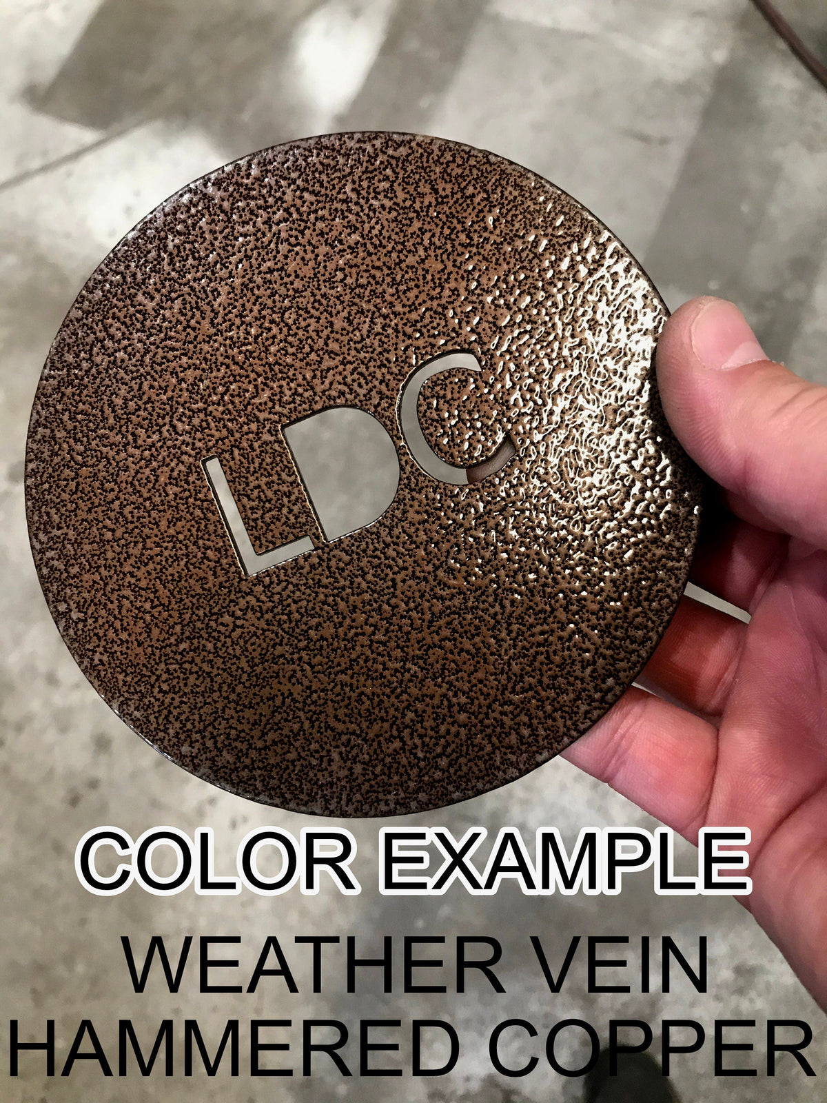 Weathered hammered copper round metal color sample with “HC” cutout