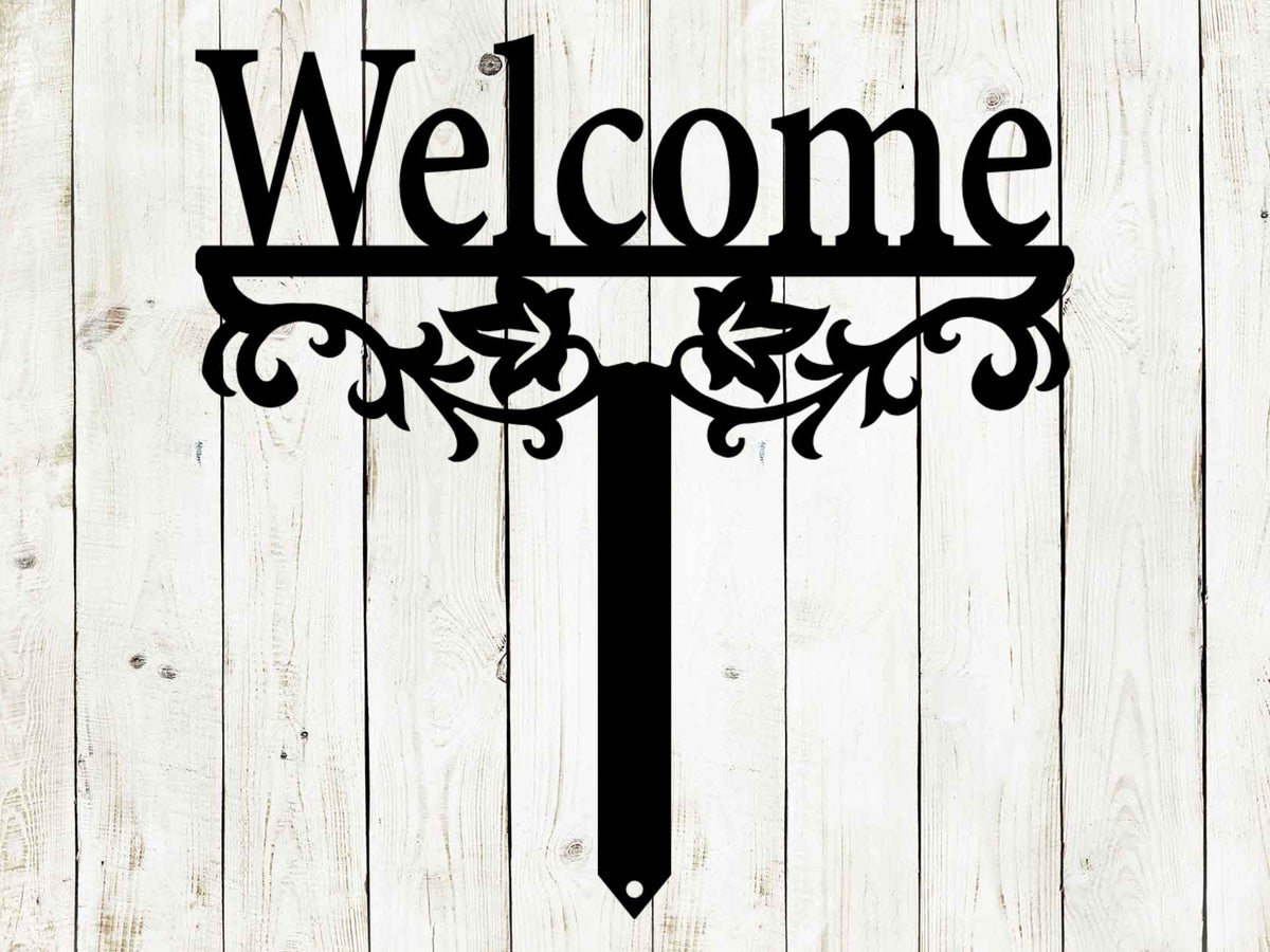 Black metal "Welcome" yard stake sign with decorative scrollwork and pointed stake