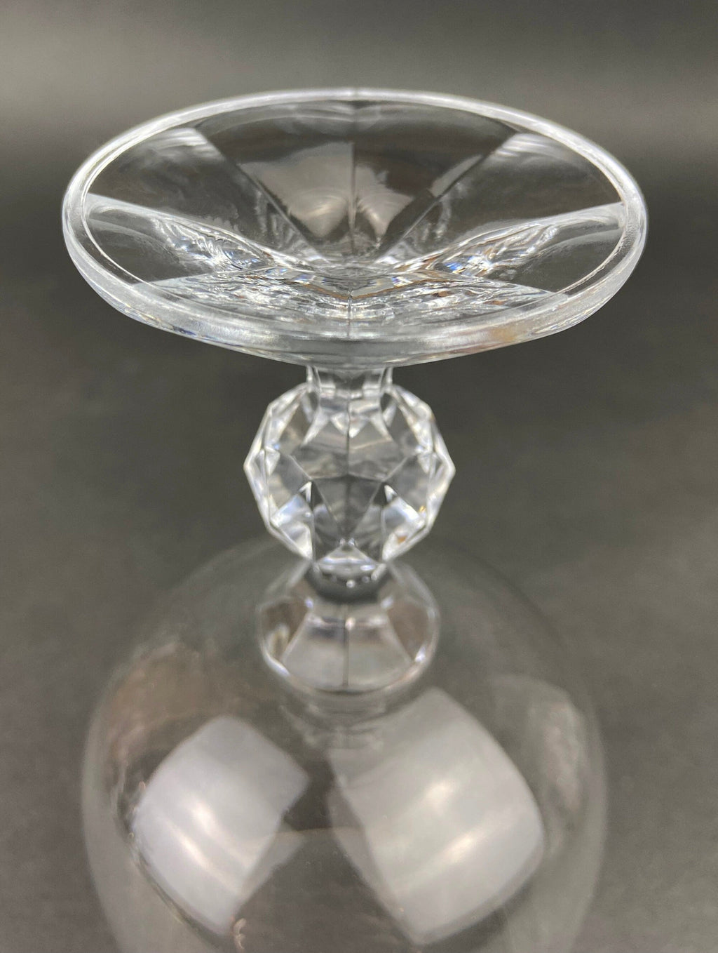 Crystal goblet with faceted stem and etched rim, close-up