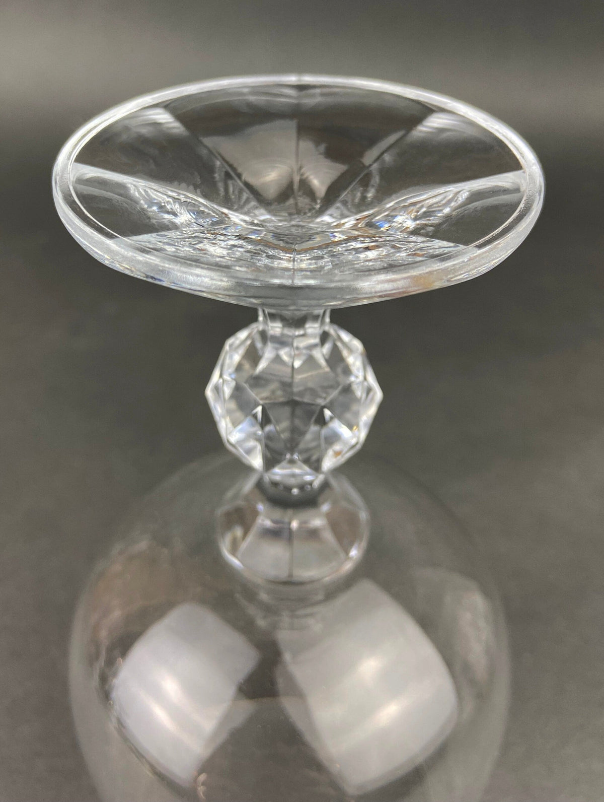 Crystal goblet with faceted stem and etched rim, close-up