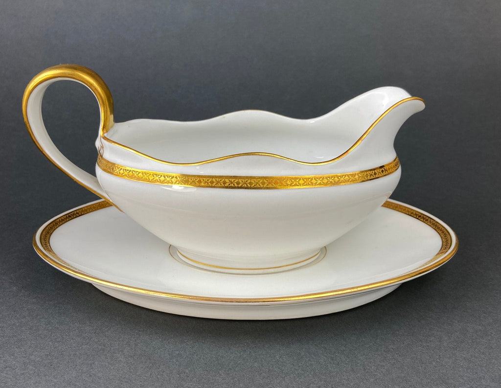 Porcelain gravy soup boat with gold handle and gold rim band, white with gold trim