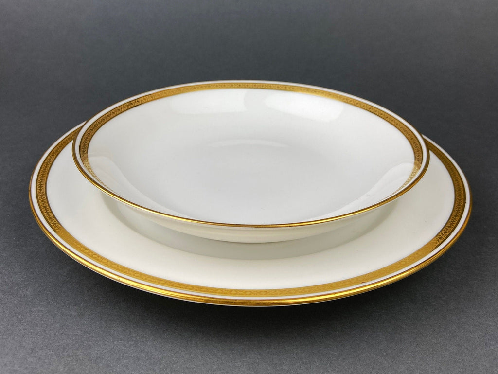 White porcelain oval serving plate with gold rim band and thin inner gold line