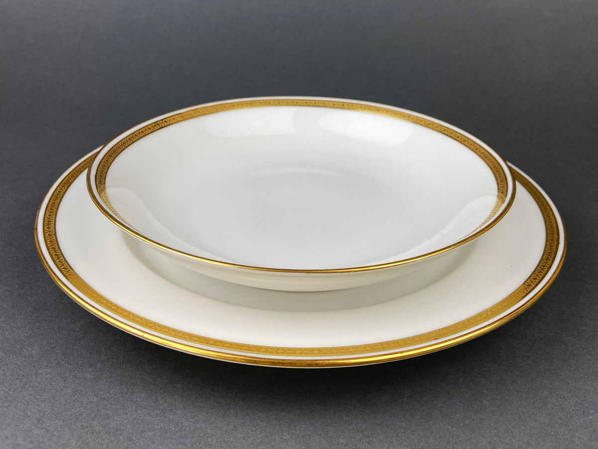 White porcelain oval serving plate with gold rim band and thin inner gold line